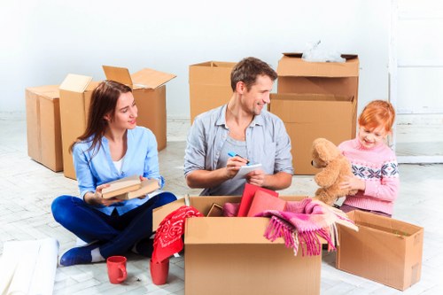 Packed moving boxes and furniture in a Limehouse home removal