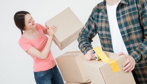 Boxes and furniture being unloaded into a Limehouse property by house movers